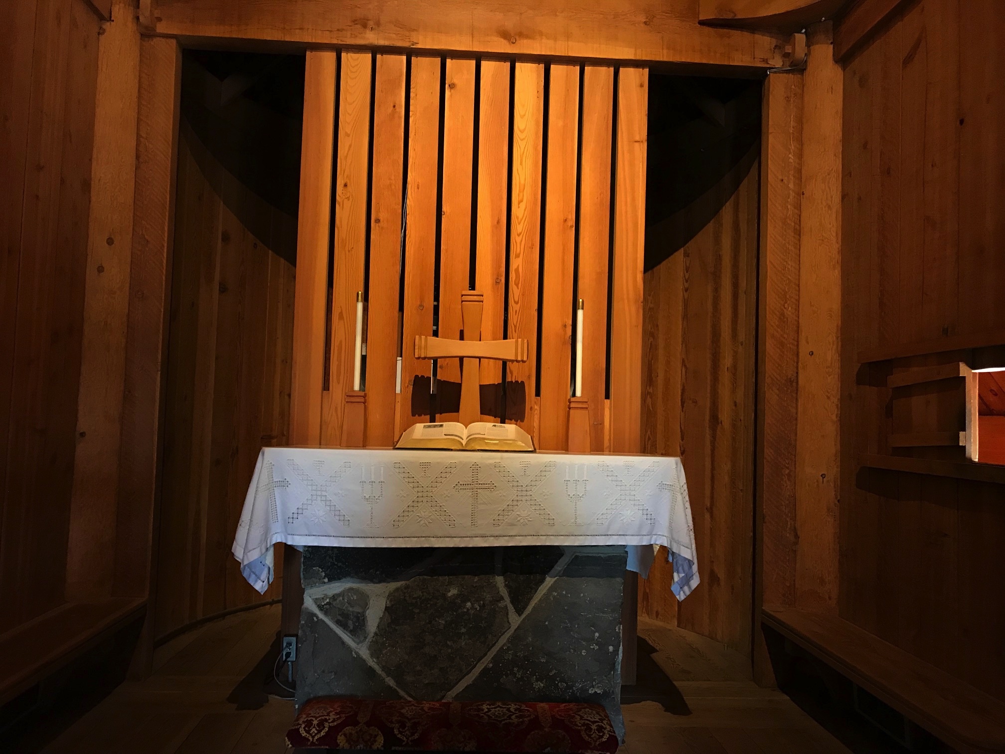 Stone altar of a church with a wooden backdrop