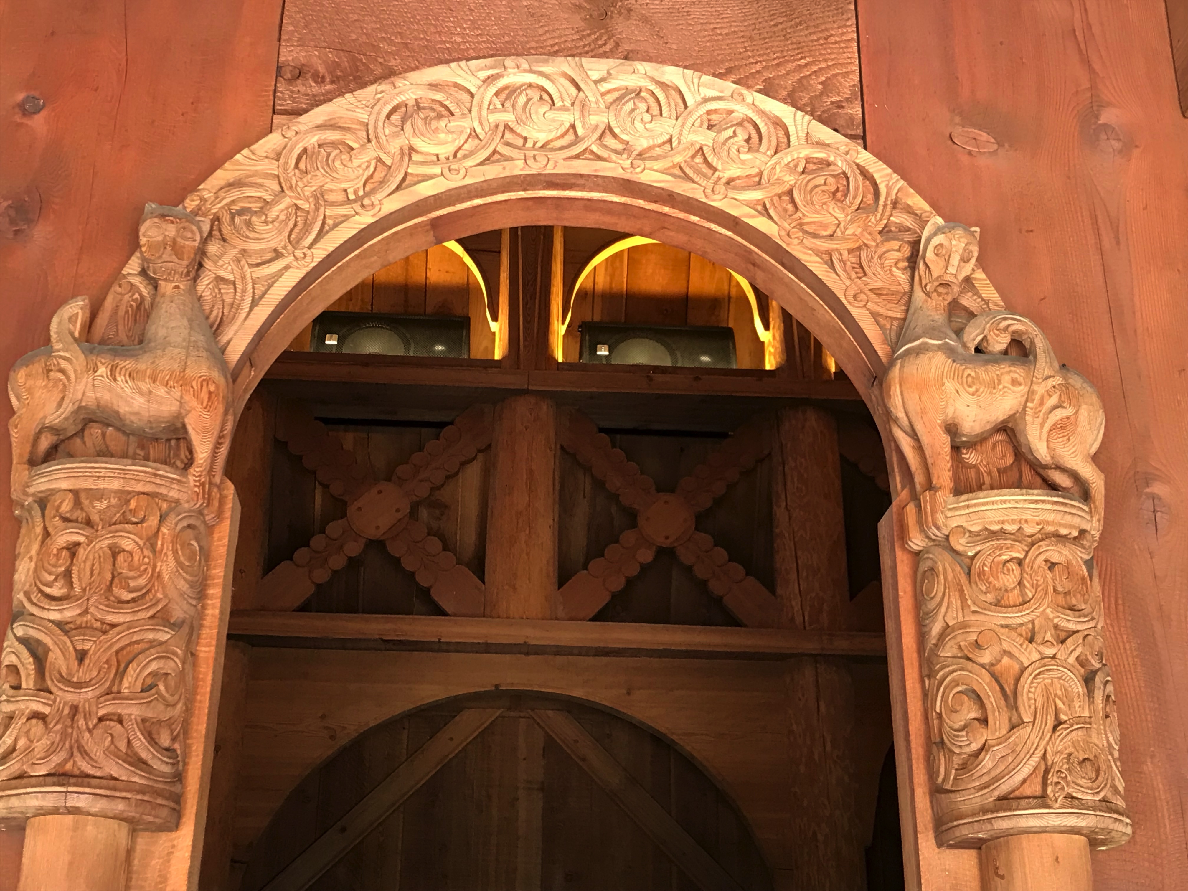 Wooden entrance to a church with an ornate border